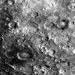 Mercury’s dark haloes: Some young craters show incomplete haloes of darkened material around their rims. The crater in the lower left part of this image is about 100km in diameter, and the crater in the upper right is about 70km across.