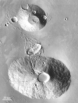Ceraunius Tholus (bottom ) and Uranius Tholus (top) on Mars (~130 and ~60 km diameter). The radial and later sinuous channels suggest that the material was easily erodable, ash rather than lavas, and the steep conical piles support this (THEMIS).