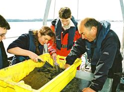1. Year 10 students investigating sea bed sediments with Dr Simon Boxall on the School of Ocean and Earth Science research training vessel Callista