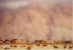 Approaching dust storm in a hot desert.