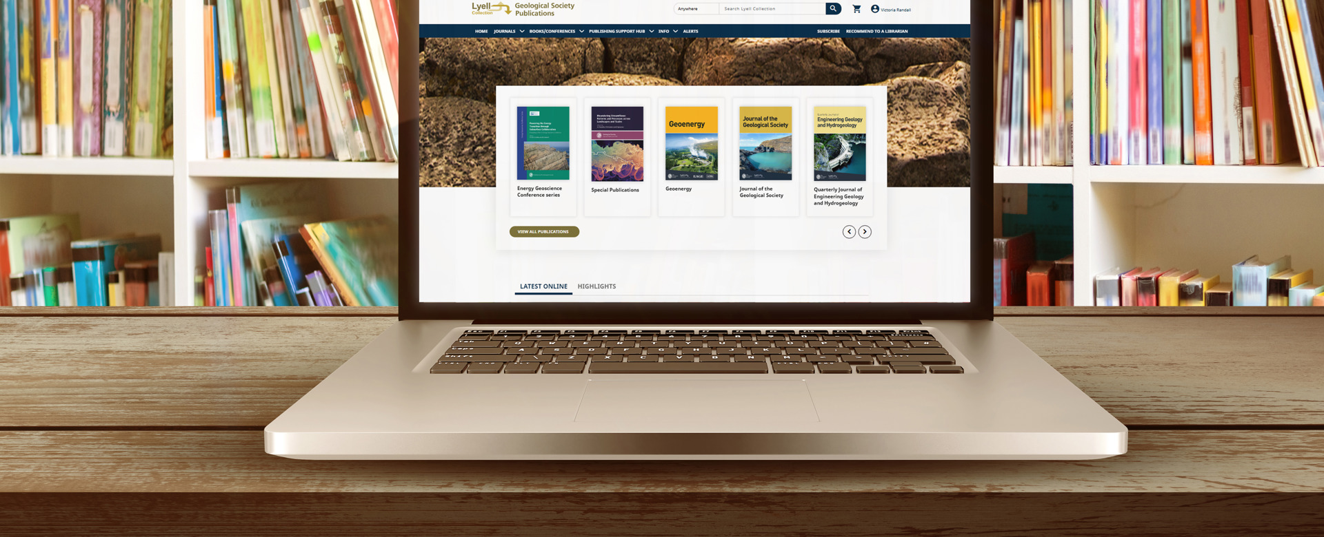 An open laptop in a library open with the Lyell page