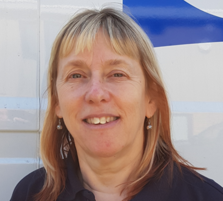 white woman with medium length blond hair and a fringe