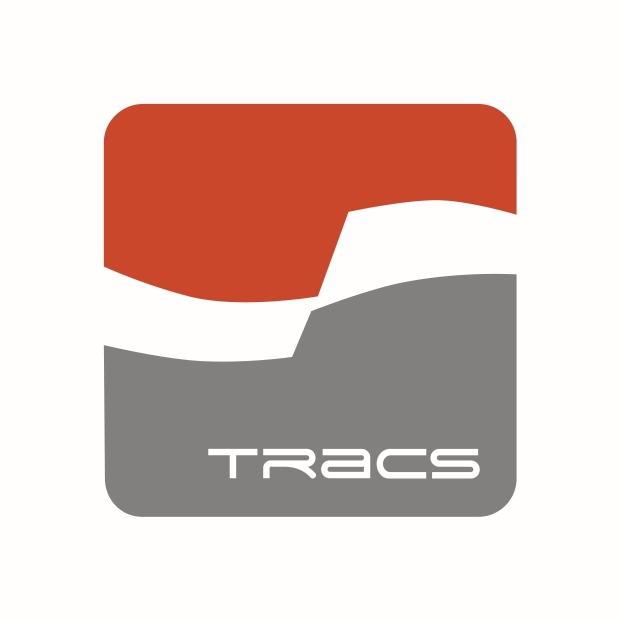 Logo with the word "TRACS" in white, set within a rounded square divided into a red upper section and a gray lower section, separated by a white curved shape.