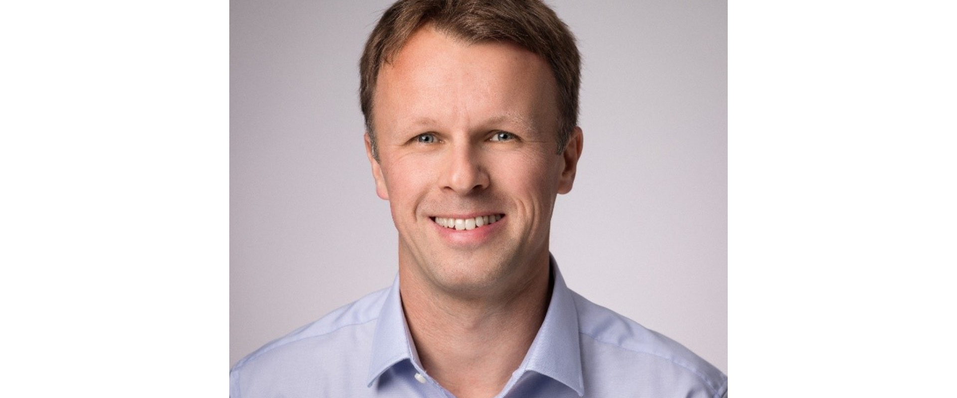 Close-up professional headshot, collared shirt