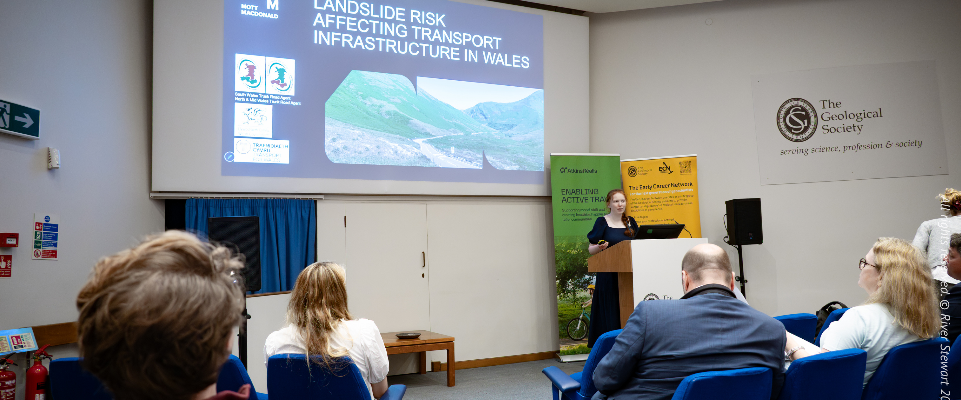 Woman gives a presentation to judges in a lecture theatre