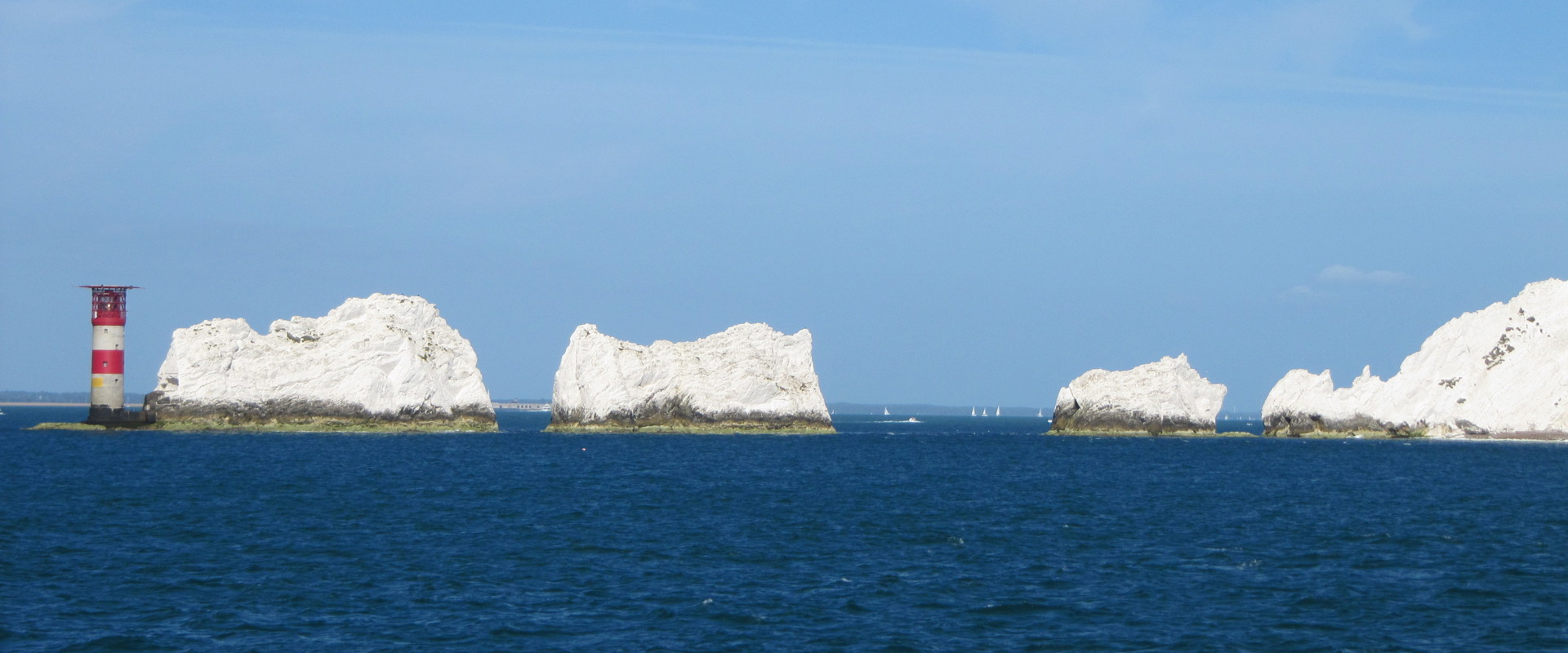 Image showing the Needles lighthouse at the Isle of Wight - a red and white striped lighthouse in the sea next to a range of white chalk stacks