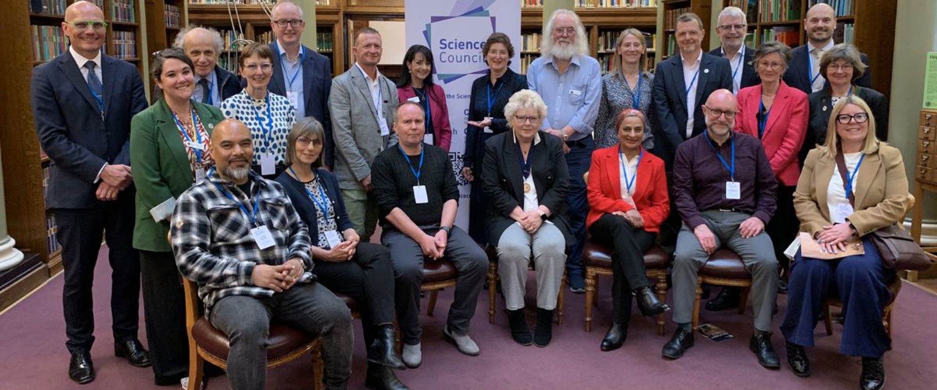 Senior representatives from the Science Council's Member Bodies and Learned Societies posing in the Geological Society's Library during the President's Roundable meeting