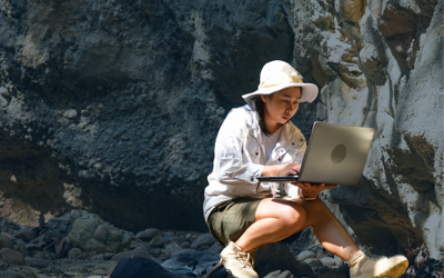 Woman conducting fieldwork research with a computer in hand