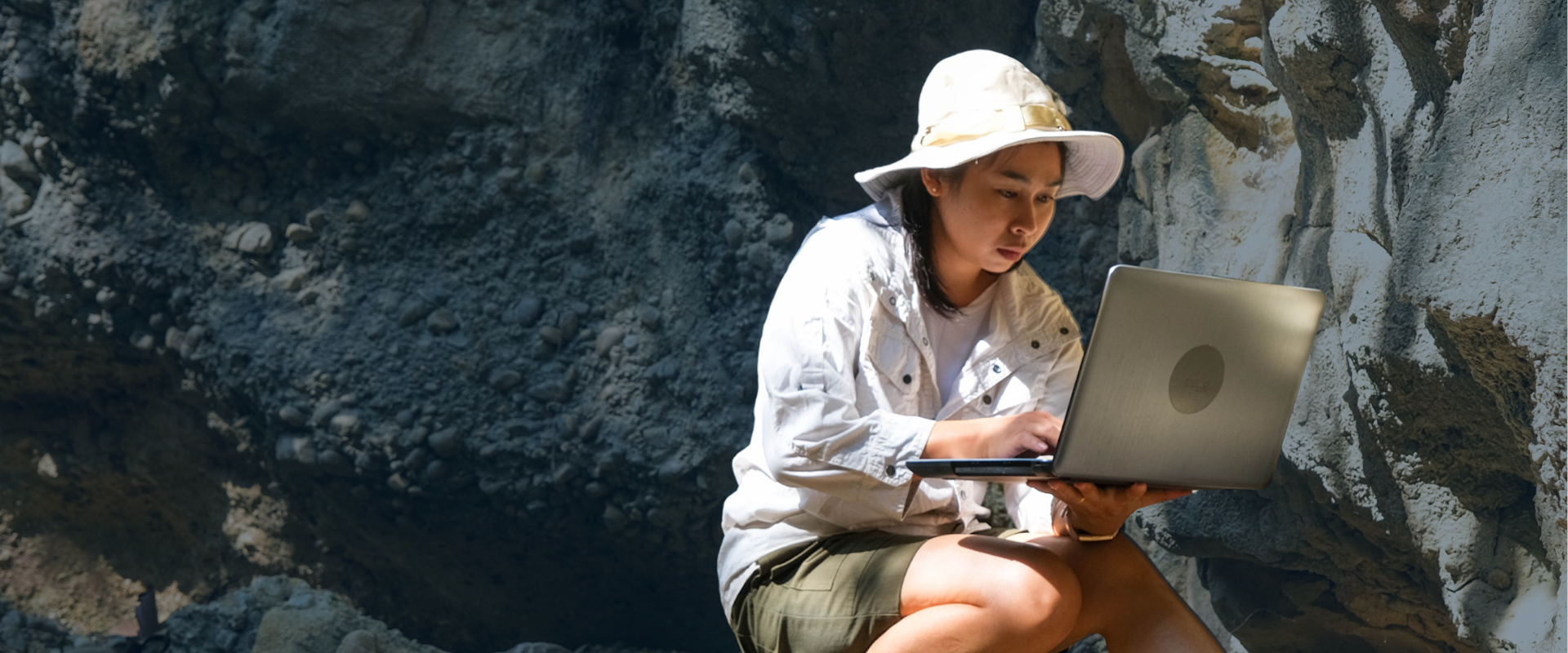 Woman conducting fieldwork research with a computer in hand
