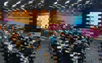 people sitting in a lecture theatre listening to a talk