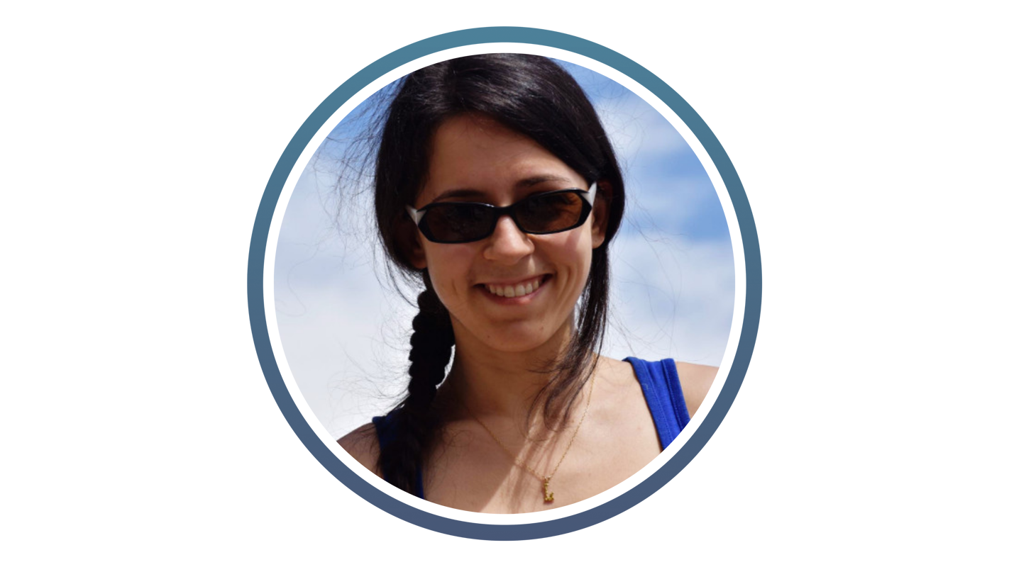 young woman with long dark hair tied back and dark sunglasses