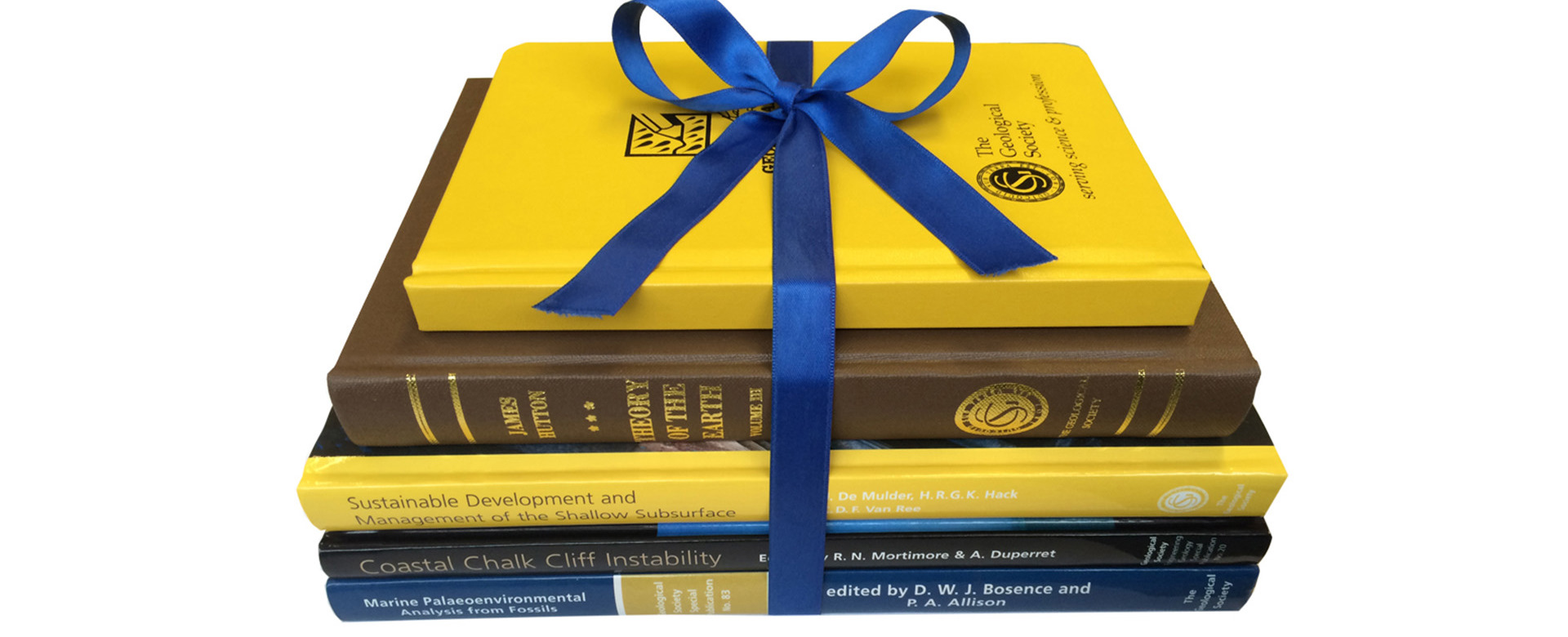 A pile of publications from the Geological Society and other publishers tied with a blue ribbon.