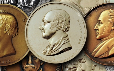 three medals with two gold and a silver one in the middle