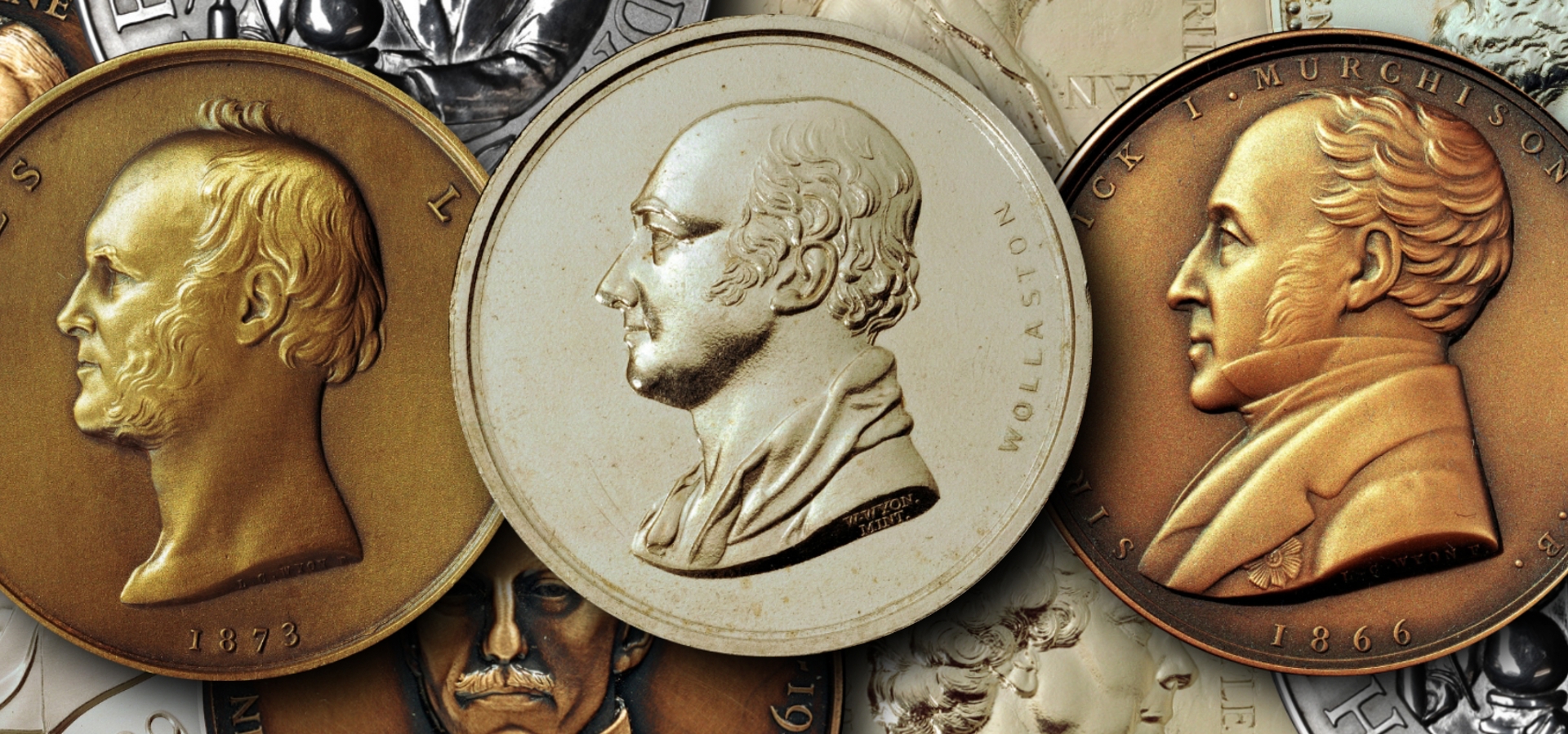 three medals with two gold and a silver one in the middle