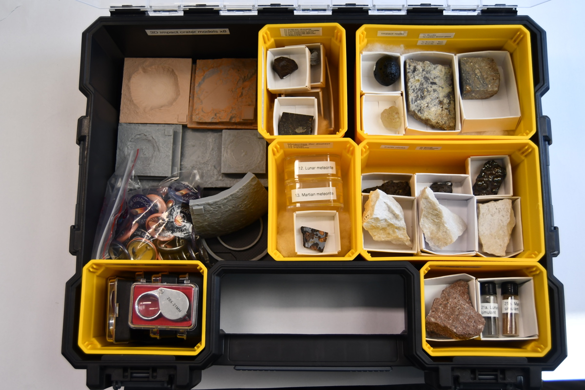 an open box filled with smaller open boxes containing various rock samples