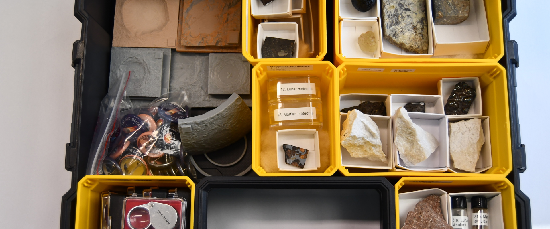 an open box filled with smaller open boxes containing various rock samples
