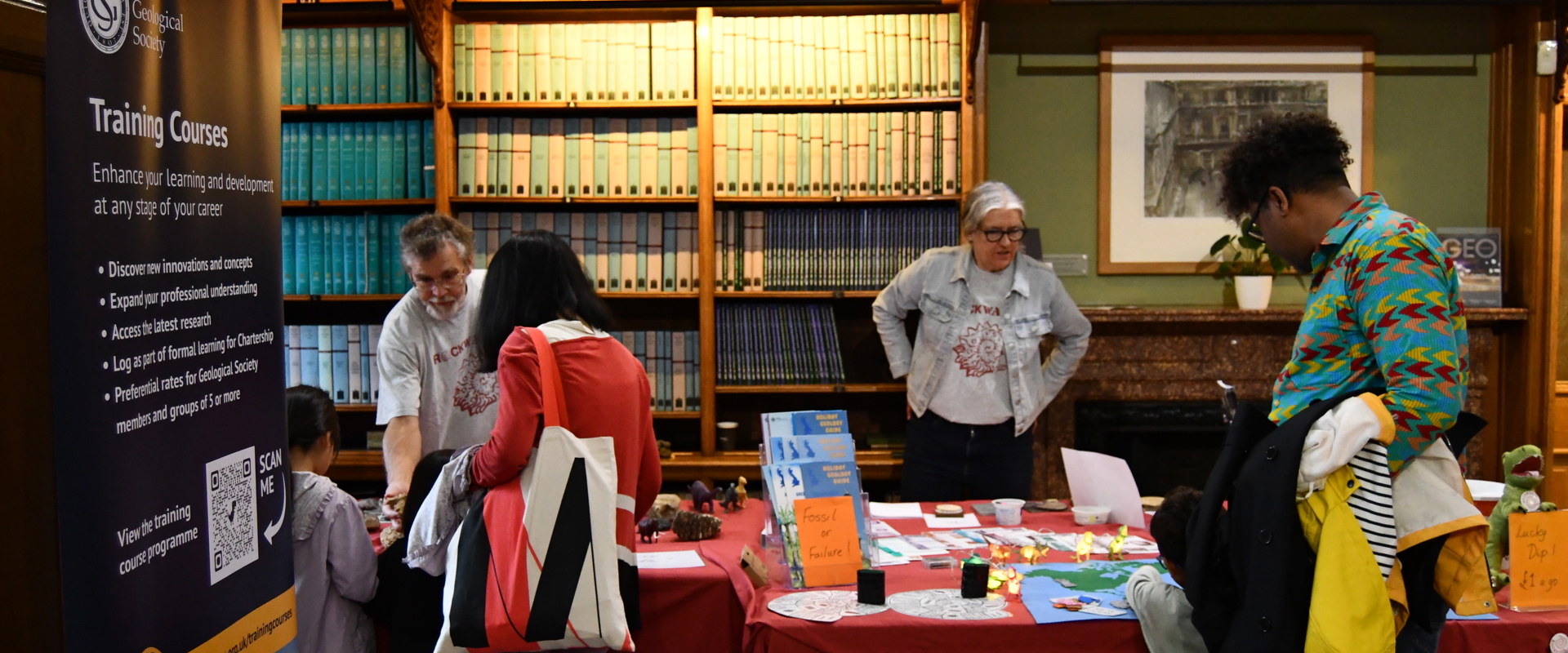 A group of diverse individuals gathered around a table, engaged in conversation and sharing ideas.