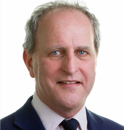 white man with grey hair and suit and tie