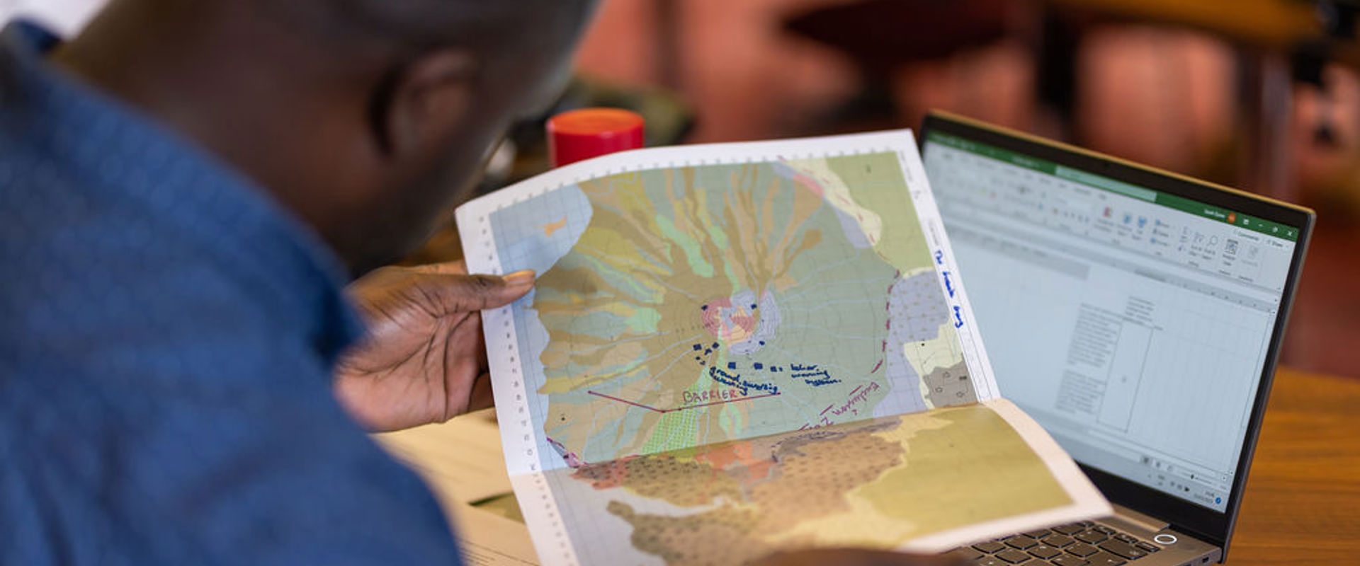 A judge looking at a marked with an evaluation spreadsheet on the background