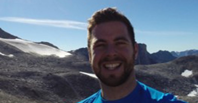 white man in front of mountains