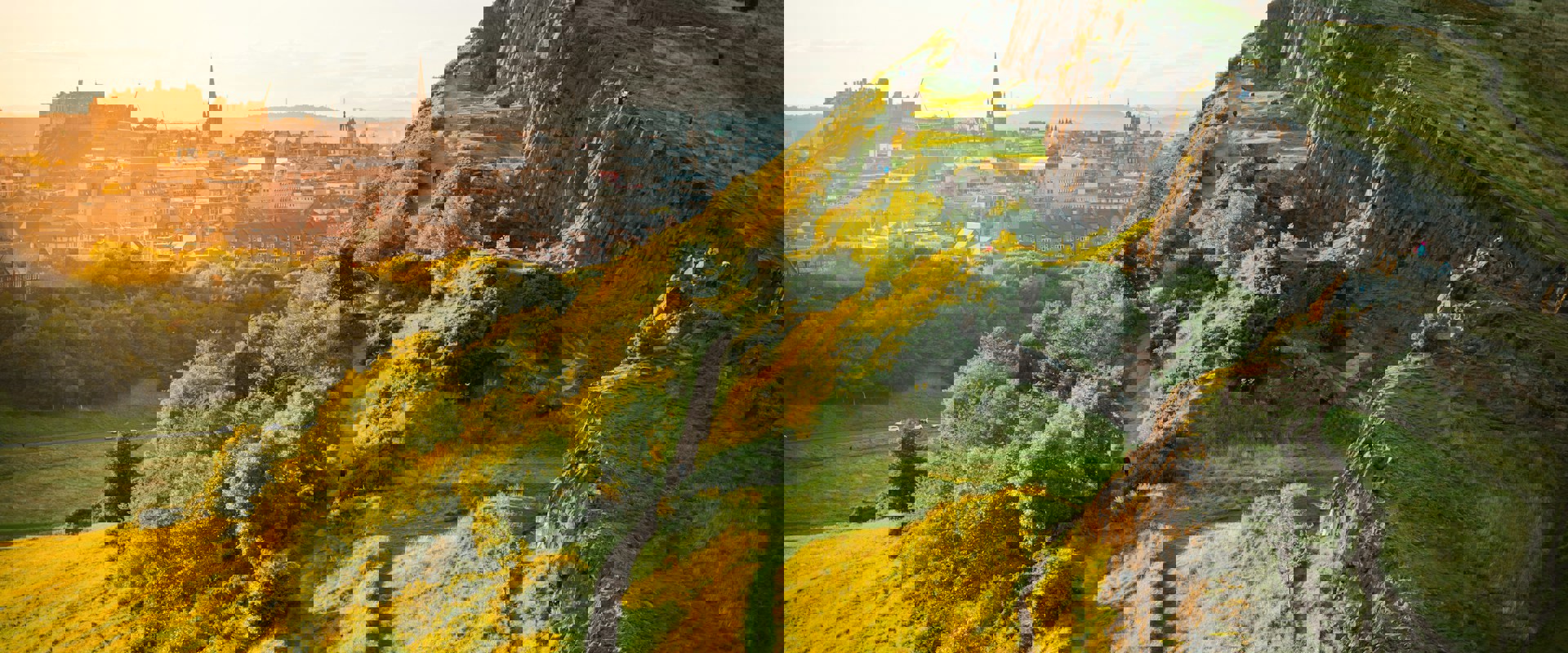 Arthurs Seat mountain overlooking Edinburgh's skyline in the distance