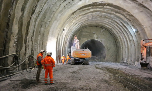 Two figures in orange boiler suits - boring tunnel shaft