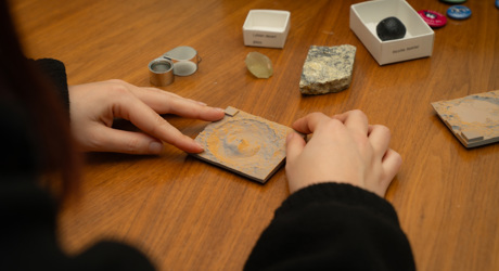 Close up of hands holding a square piece of stone