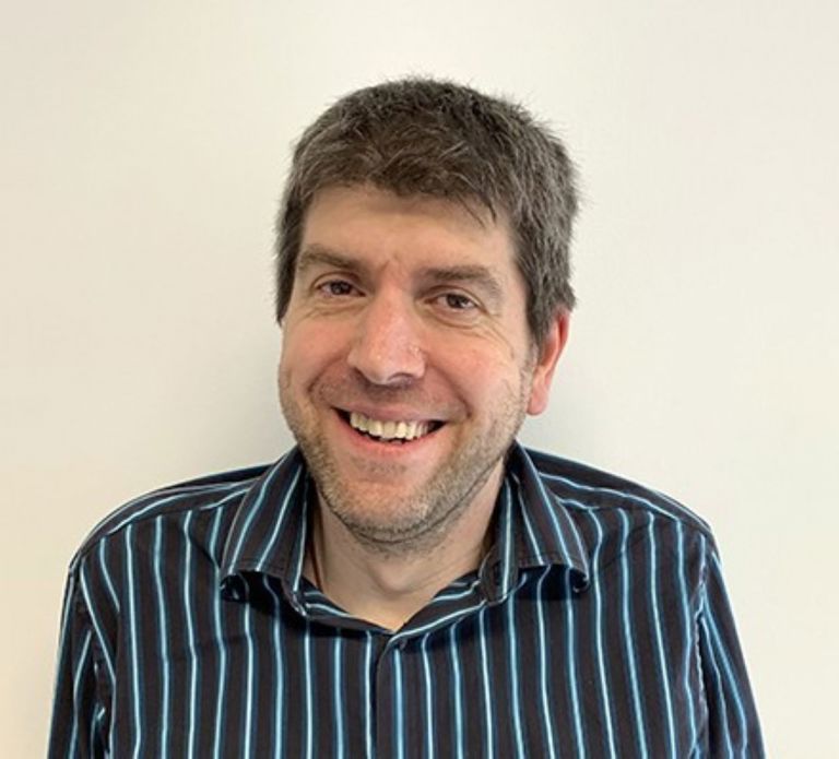 white man with short hair wearing a stripy shirt