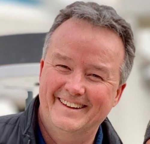 white man with short grey hair smiling