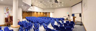 blue seats in a lecture theatre