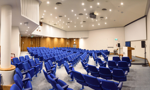 blue seats in a lecture theatre