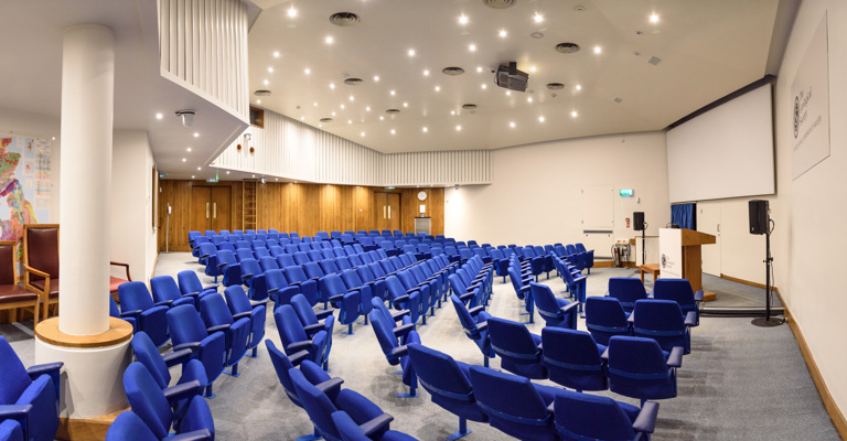 blue seats in a lecture theatre