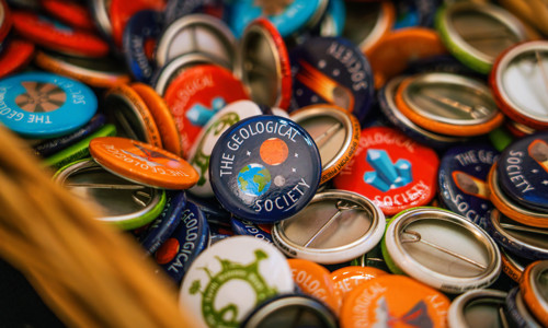 close up of colourful badges with the geological society written on them