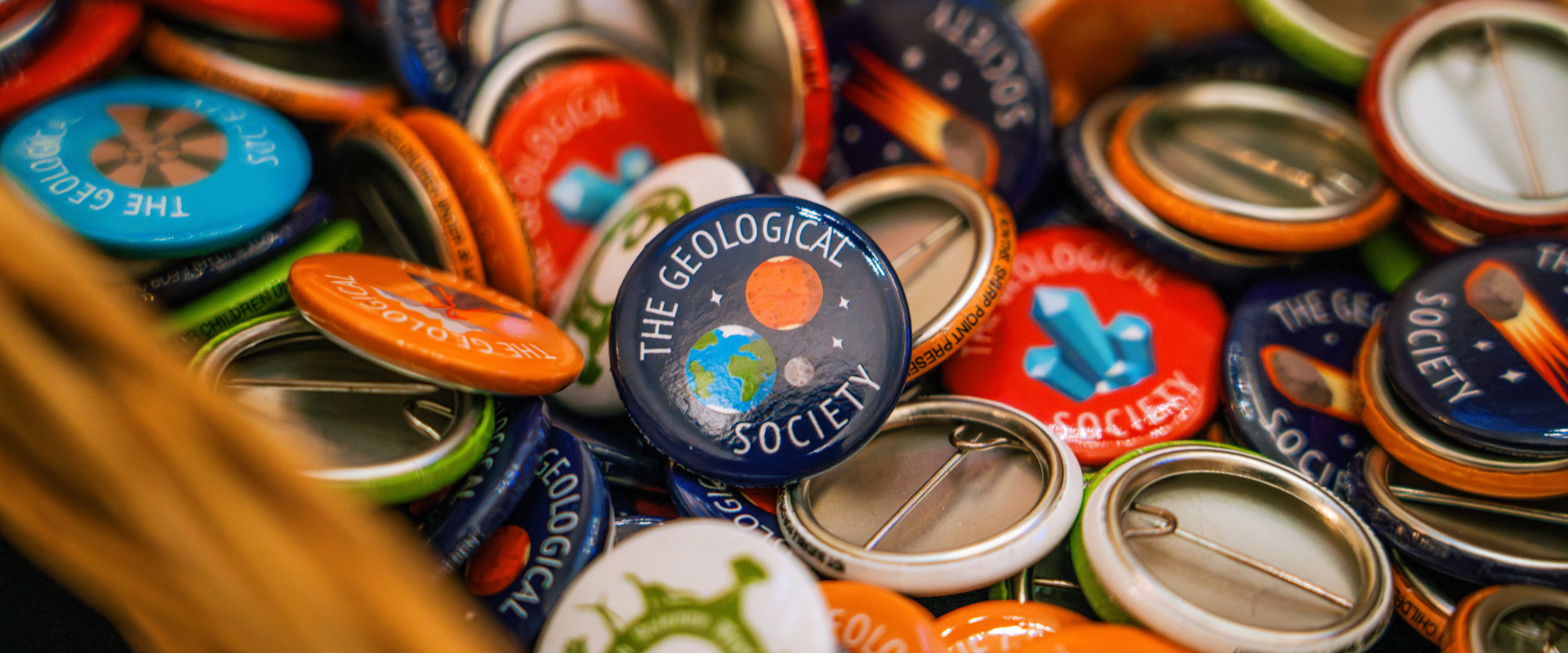 close up of colourful badges with the geological society written on them