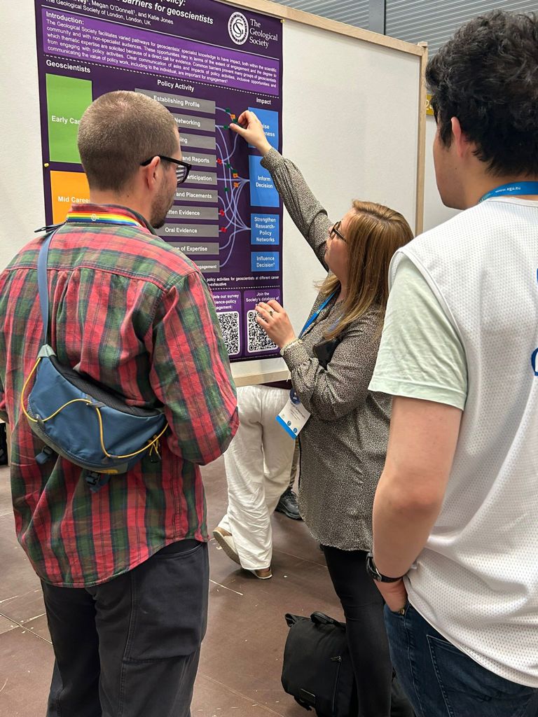 A person interacting with a poster presentation during EGU26