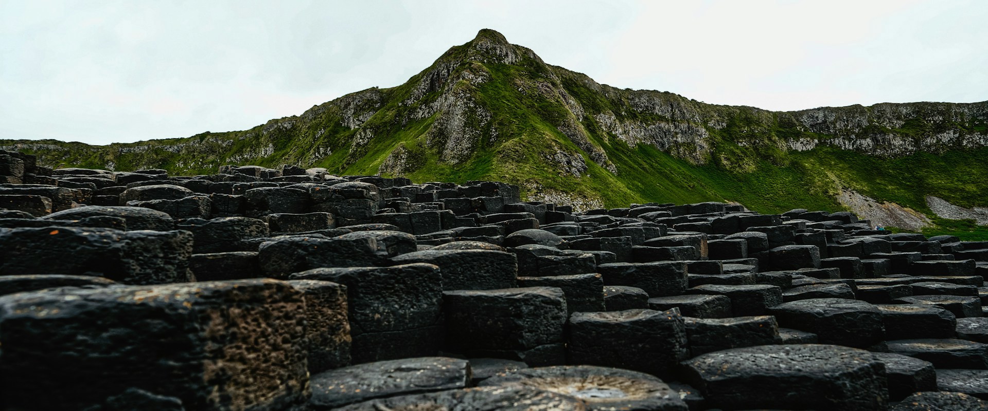 stones with green mountain behind