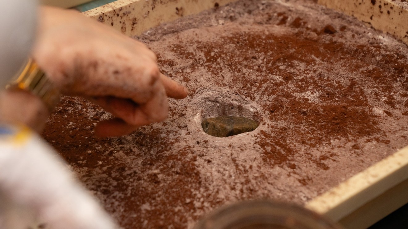 box of sand with a whole in the middle