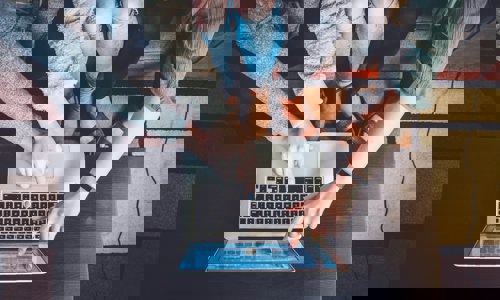 Group pointing at a laptop screen