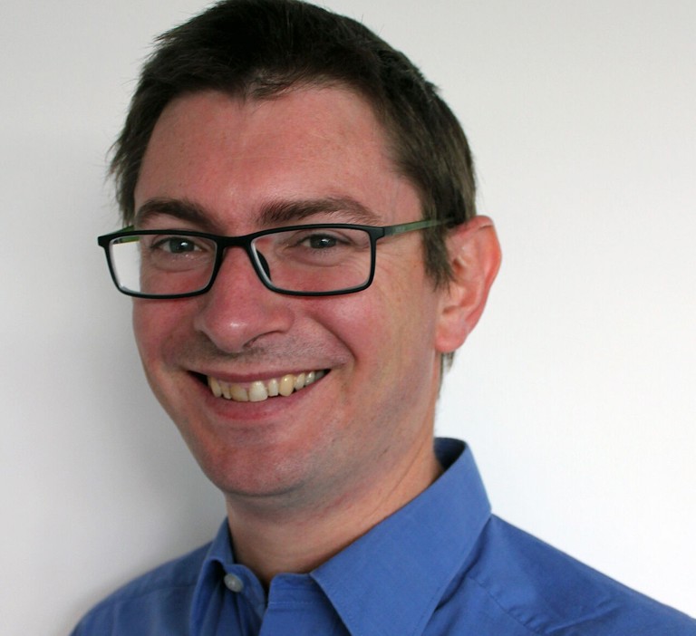 white man with glasses and a blue shirt