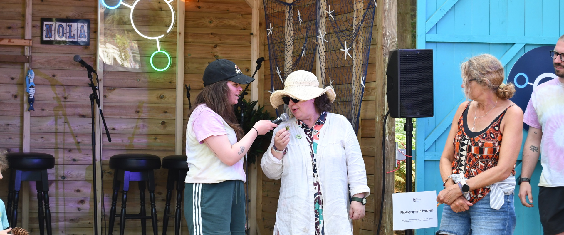 Performer speaking to participant on stage
