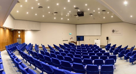 A 172-seat Lecture Theatre with blue chairs and a large projector screen.