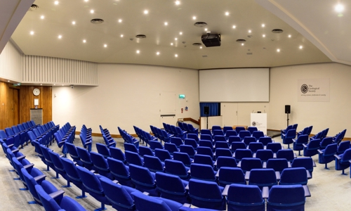 A 172-seat Lecture Theatre with blue chairs and a large projector screen.