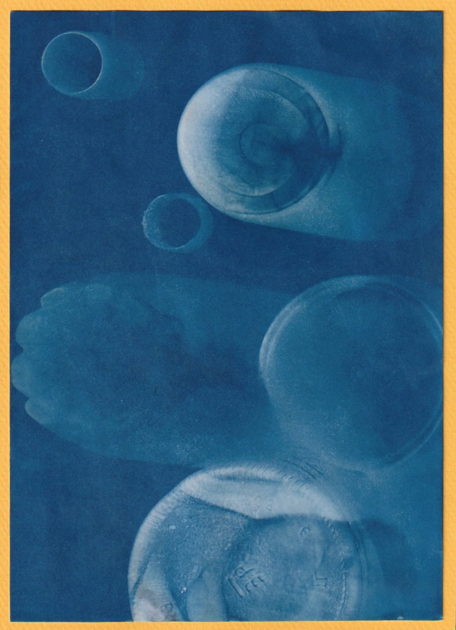 A scan of a cyanotype image whowing bottle bottoms, represting the 'roundest thing' found. 