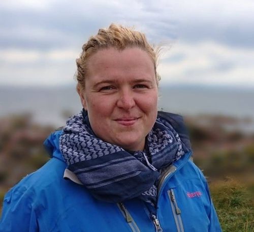 blond woman with blue jacket on