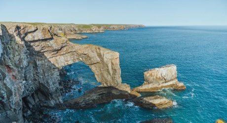 Natural limestone arch along the Pembroke coast in Wales, UK (Shutterstock)