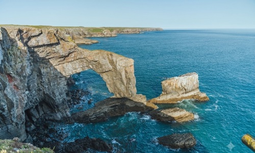 Natural limestone arch along the Pembroke coast in Wales, UK (Shutterstock)