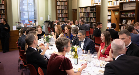 A group of delegates enjoying a sit-down dinner in the Upper Library.