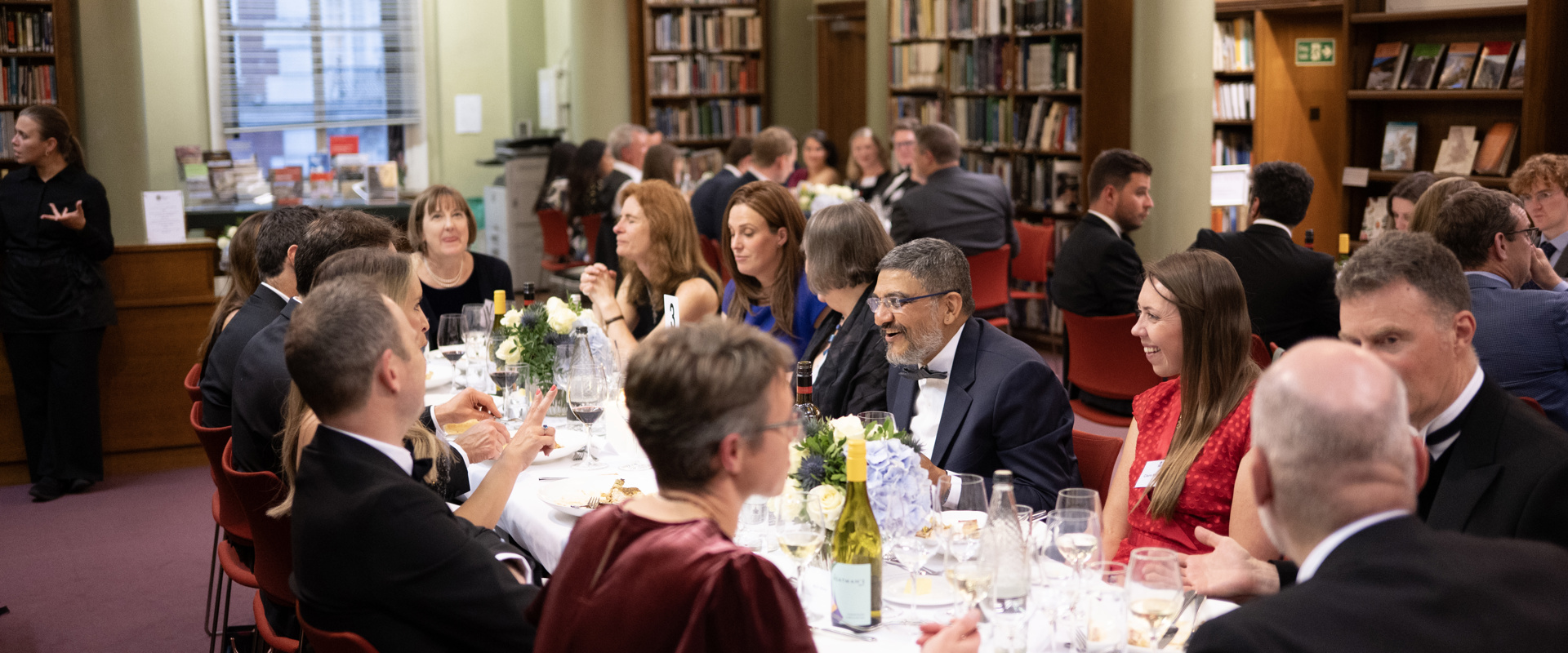 A group of delegates enjoying a sit-down dinner in the Upper Library.