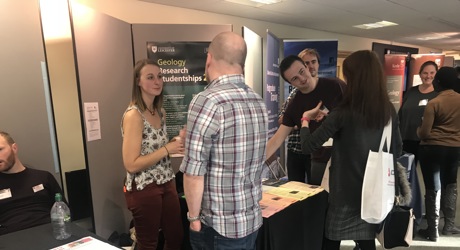 woman speaking to a man stood at an exhibition event
