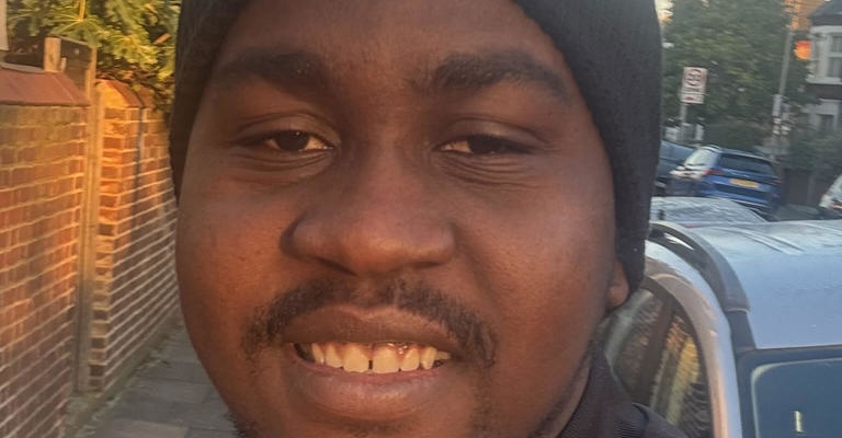 black man wearing a dark blue beanie hat